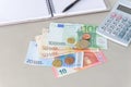 Euro money banknotes and coins counting with calculator, notebook and pen Royalty Free Stock Photo