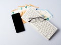 Euro money banknotes, keyboard, smartphone and glasses, online banking, business, student loan concept