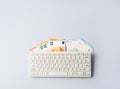 Euro money banknotes under keyboard, online banking, sale of digital info products concept