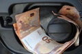 Euro money in car fuel tank opening. Royalty Free Stock Photo