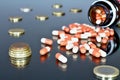 Euro money with medicaments. Mirroring eurocoins and pills. Royalty Free Stock Photo