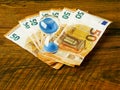 Euro notes on a wooden table and blue sand clock. Time to pay or invest concept. Banking and finance industry. Time frame for Royalty Free Stock Photo