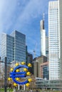 the Euro sign in Frankfurt in front of skyscraper and the former european central bank building