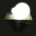 Euro stack with shiny lightbulb Royalty Free Stock Photo