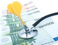 Euro with stethoscope and darts Royalty Free Stock Photo