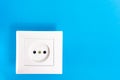 Euro type electrical outlet, electric power point in the house, on a blue background. The concept of power supply, electrical Royalty Free Stock Photo