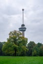 Euromast observation tower in Rotterdam, Netherlands. City park trees and green grass