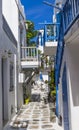 Europe. Greece. Cyclades. Mykonos island. A courtyard on traditional narrow street with blue door, window and balcony and white