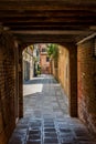 Italy, Venice, a stone building that has a bench in front of a brick wall