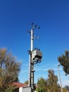 Europe. Poland country. Electrical technology. Tranformer of pawer in sunlight on a blue sky background. Electrical equipment of n