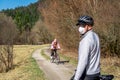 EUROPE - Slovakia, 25. May 2020: Old Woman Cycling with a Mask on her Face