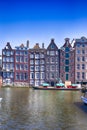 Europe Travel Concepts and Ideas. Row of Traditional Ancient Houses At Damrak Canal in the Capital of The Netherlands in Amsterdam Royalty Free Stock Photo