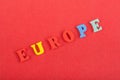 EUROPE word on red background composed from colorful abc alphabet block wooden letters, copy space for ad text. Learning english Royalty Free Stock Photo