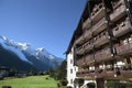European alpine ski chalet hotel, view of the Alps in distance, copy space Royalty Free Stock Photo