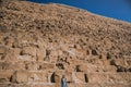 A European blonde walks near the pyramids in the desert in Cairo