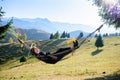 Relaxation. Women in hammock in autumn. mountain view