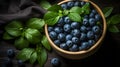 European blueberry and green leaves in a wooden bowl