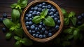 European blueberry and green leaves in a wooden bowl