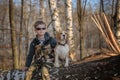 European boy and Beagle dog sitting on a tree in the woods