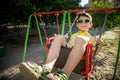 European boy on chain swing. Summer leisure time concept Royalty Free Stock Photo