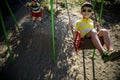 European boy on chain swing. Summer leisure time concept