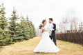 European bride and groom dancing in the park