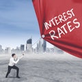 European businessman pulls text of interest rates Royalty Free Stock Photo