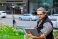 European Businessman traveling, working in New York with gray hair, working on laptop computer