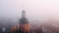 Europian city center covered in fog or mist with doves