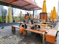 European city street, urban cafe with empty tables without people during quarantine. McDonalds open veranda with food to go.