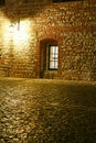 European cobbled street with lantern and window by night