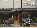 European coffee shop's facadewith motorbike and bicycle