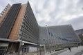 European Commission, with flags blowing in the wind in front of it Royalty Free Stock Photo