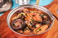 Minestrone stew soup with mushrooms, fish meat, squids, mussels, greens, tomatoes and shrimps Royalty Free Stock Photo