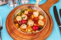 Italian fish soup with tomatoes, dough, dumplings, potatoes and greens. Mediterranean cuisine, European dish