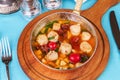 Italian fish soup with tomatoes, dough, dumplings, potatoes and greens. Mediterranean cuisine, European dish