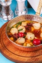 Italian fish soup with tomatoes, dough, dumplings, potatoes and greens. Mediterranean cuisine, European dish