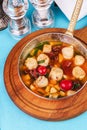 Italian fish soup with tomatoes, dough, dumplings, potatoes and greens. Mediterranean cuisine, European dish