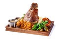 European, Czech cuisine. Pork knuckle on a wooden board with mashed potatoes, stewed cabbage, grilled vegetables and suck