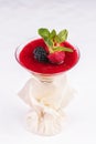 Cream mousse under the jelly of red strawberries, raspberries, served with currants, mint and strawberries in a glass Royalty Free Stock Photo