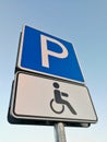 Parking sign for disabled peoples in front of blue sky Royalty Free Stock Photo