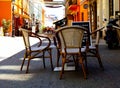 European downtown tourist street with terrace, patio furniture and tourists