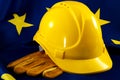 European employment in construction heavy industry, Labour day and industrial work concept with close up on a yellow hard hat and