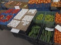 European Farmer Markets. Colourful vegetables at a traditional market. persimmon and eggs. Multicolored sweet peppers in a