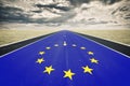 European flag, road perspective, dark clouds Royalty Free Stock Photo