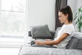 European focused woman using laptop while sitting on couch Royalty Free Stock Photo