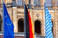 an european, a german and and bavarian flag in front of the Bavarian state parliament Royalty Free Stock Photo