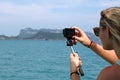 European girl tourists enjoy the GoPro camera and view of the is