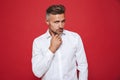 European guy with stubble in white shirt looking aside, isolated Royalty Free Stock Photo