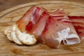 European ham called speck on wooden board with bread slices Royalty Free Stock Photo